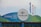 A prominently displayed SeaWorld San Diego sign with a circular logo. The background is a mix of blue and green hues, and the sign reads 'Thank You For Your Support' with an emphasis on saving animals. Colorful flags in blue, orange, and green are flying in the background.