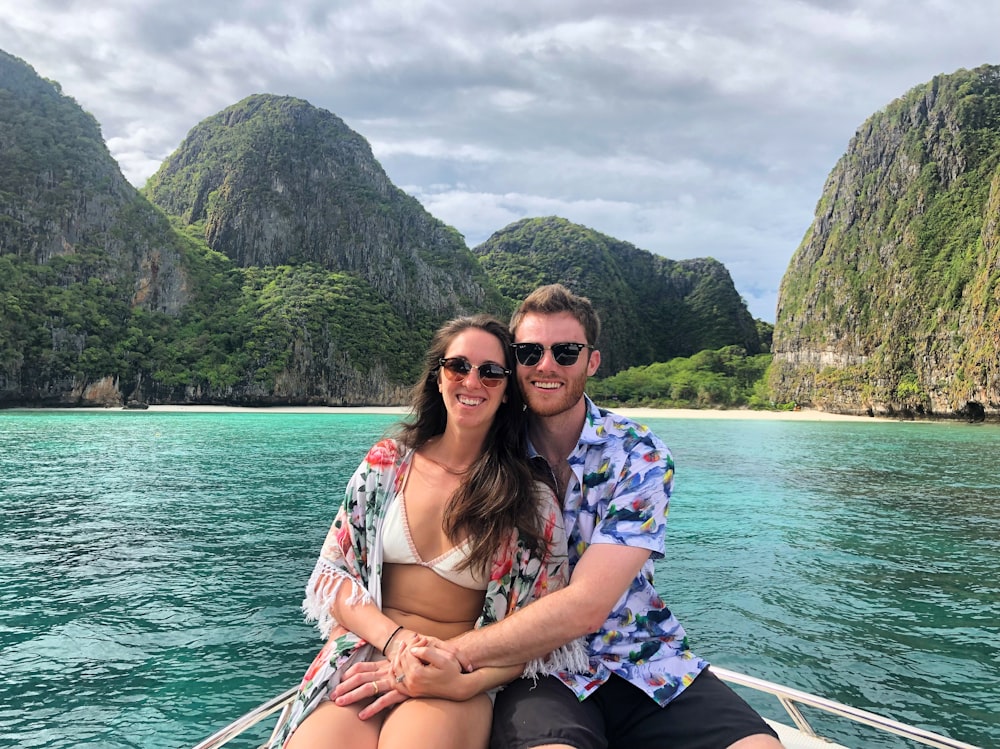 couple seated on boat during daytime