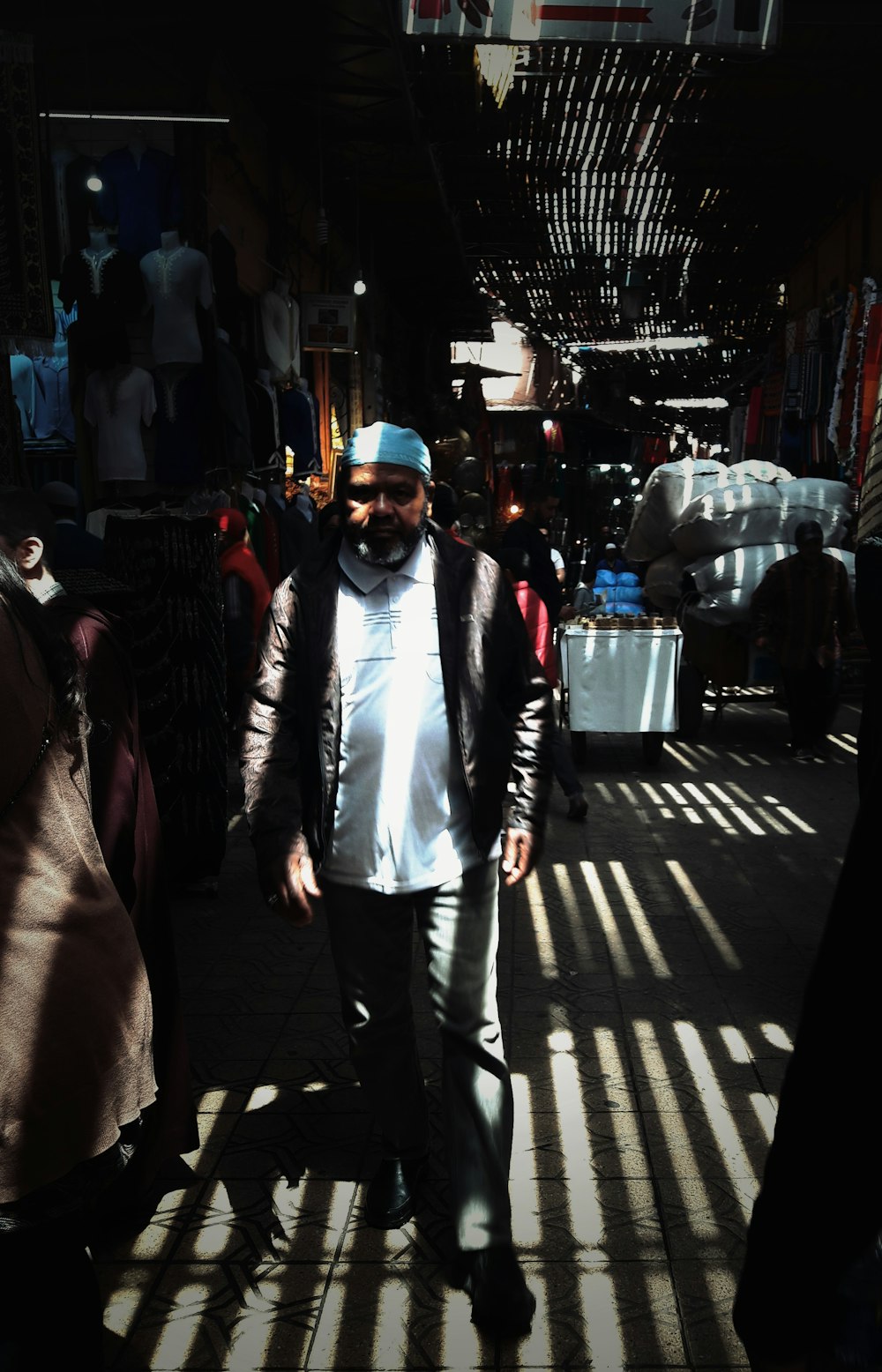 man wearing white taqiyah hat