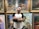 A happy customer standing next to her AI photo art.
