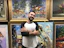 Close-up of a happy customer holding a colorful art print from Artevivo in a cozy living room.