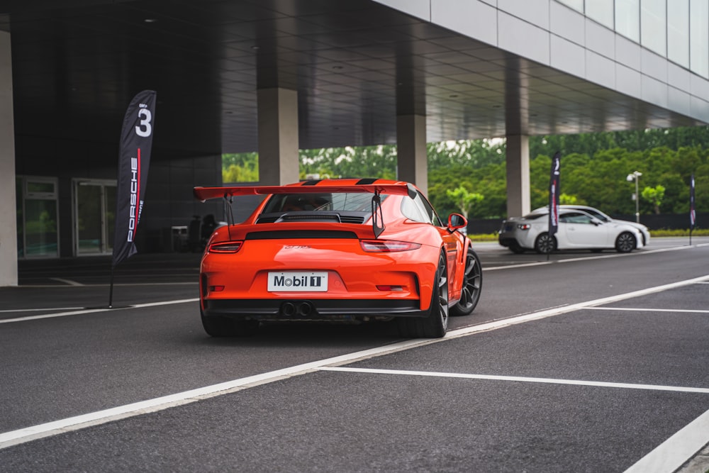 red sports car on concrete road