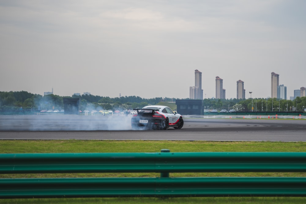 white vehicle drifting on race truck