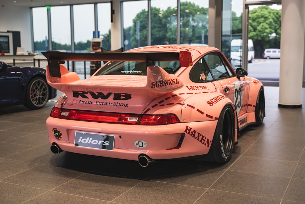 pink sports coupe parking inside building