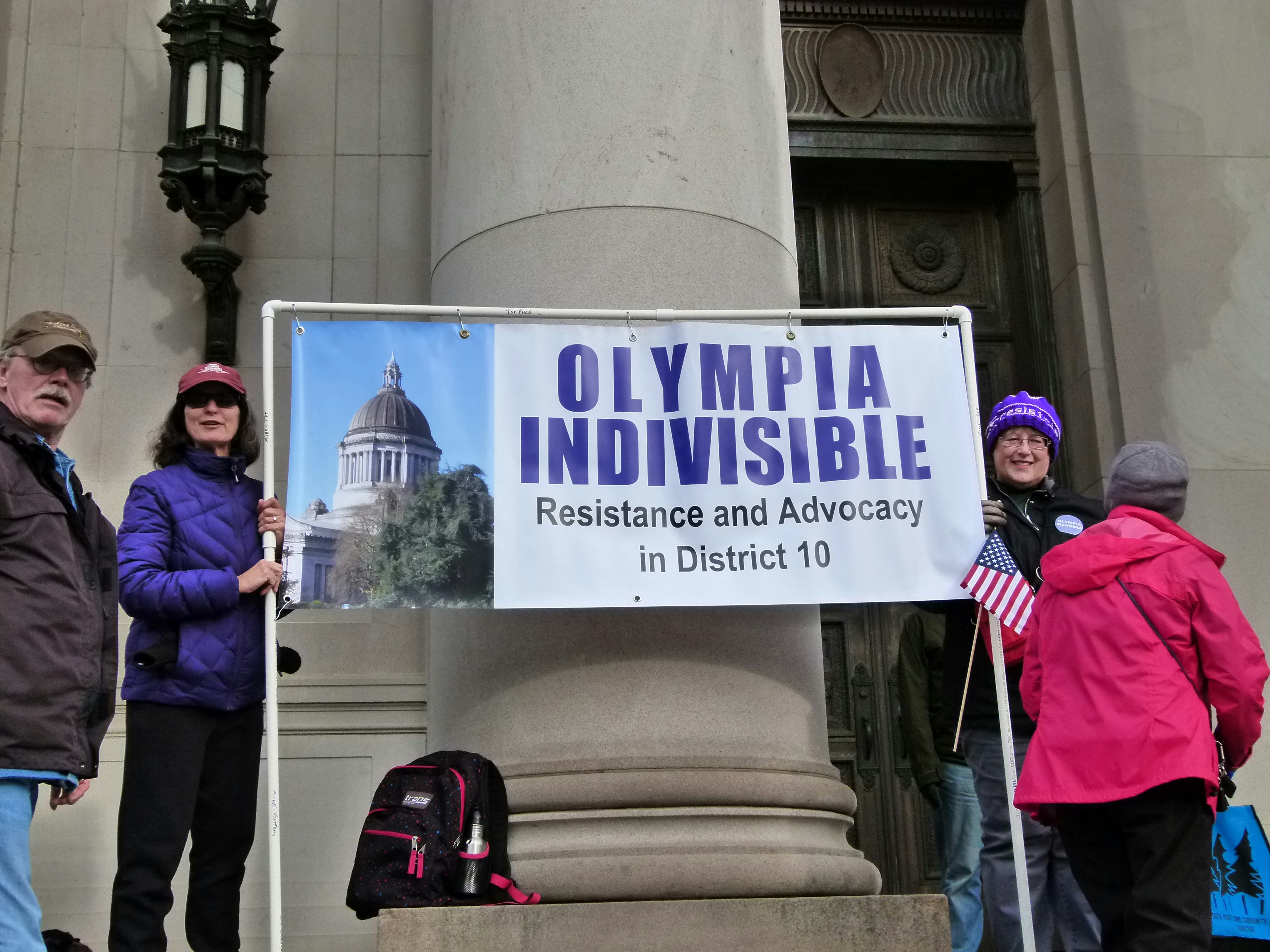 people standing near concrete building
