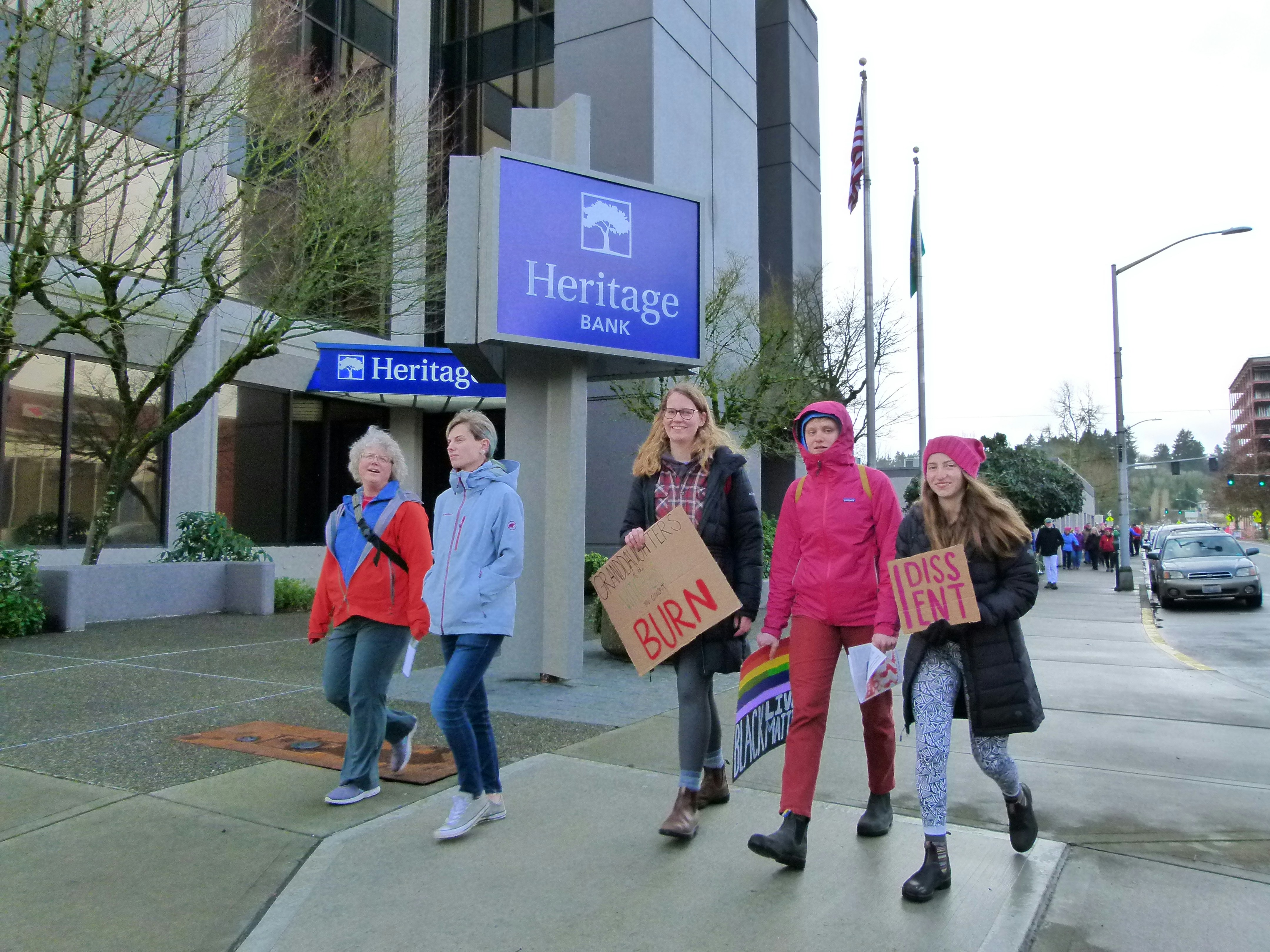 people walking beside the road and building
