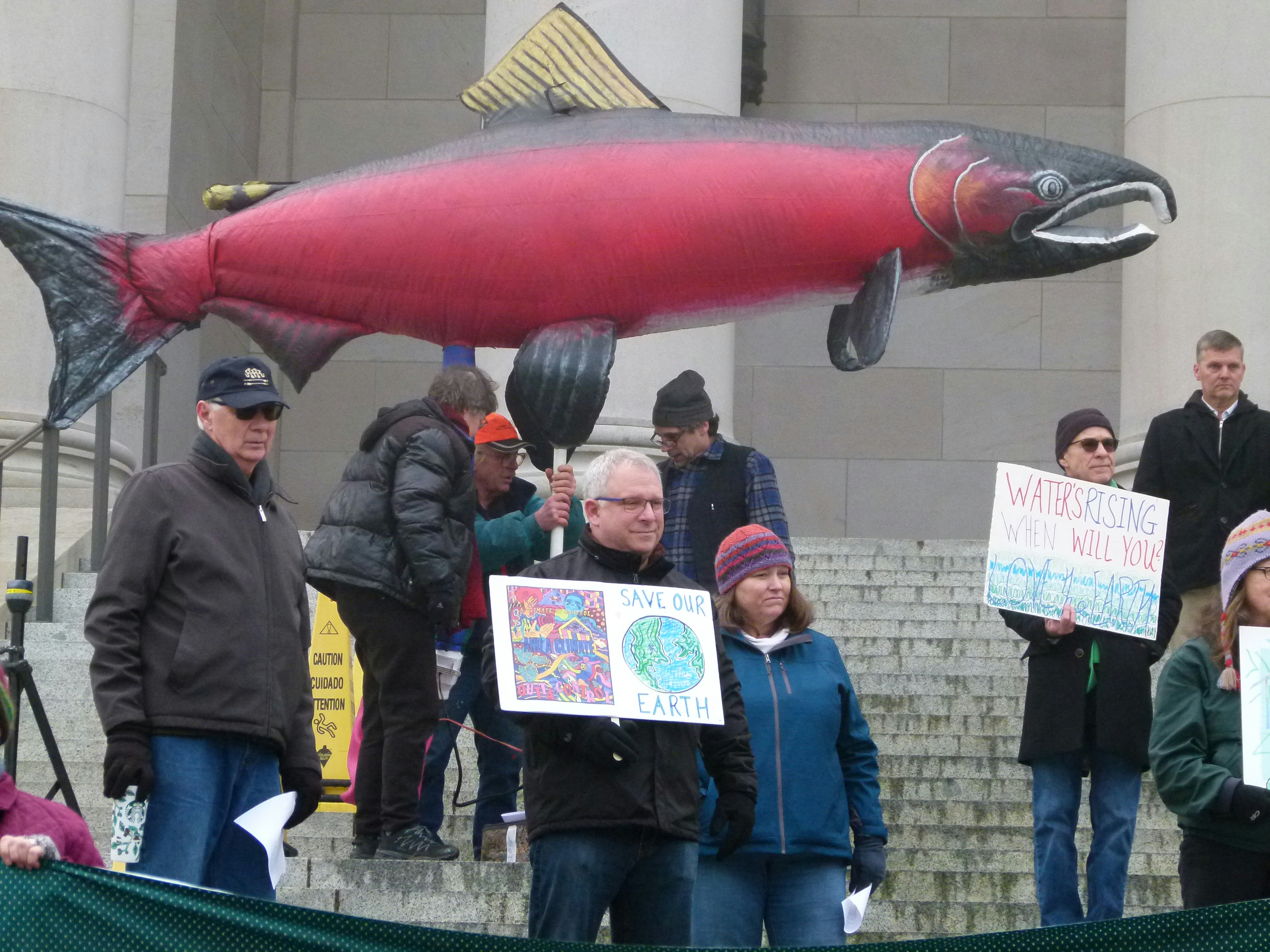 man holding salmon balloon