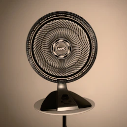 gray fan on white wooden table