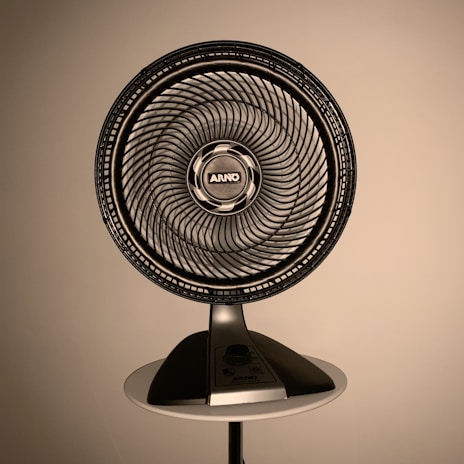gray fan on white wooden table