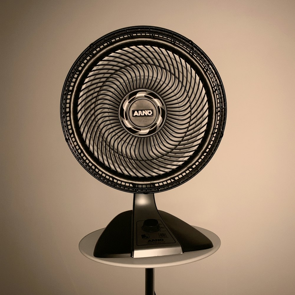 gray fan on white wooden table