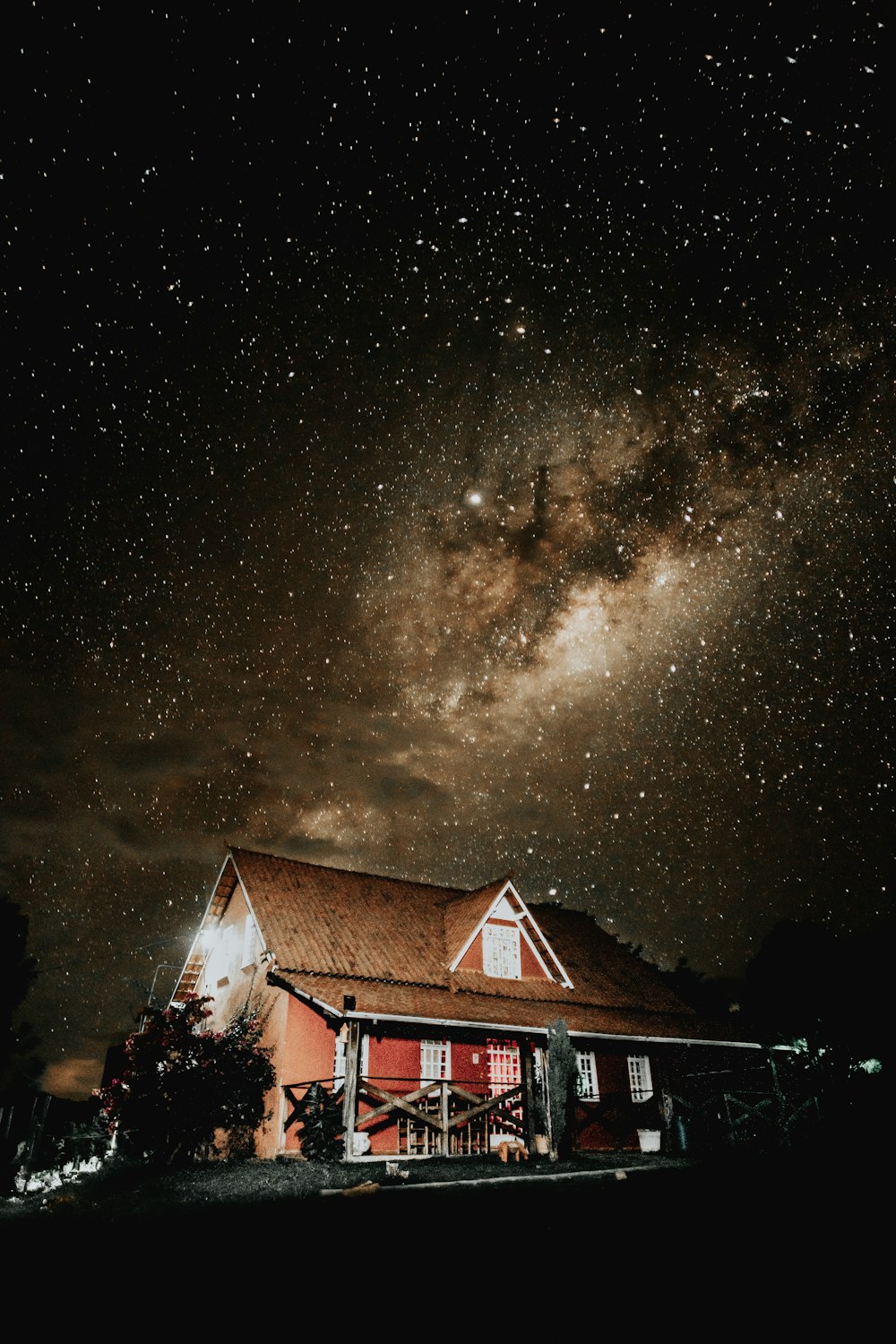 brown and red cottage at night