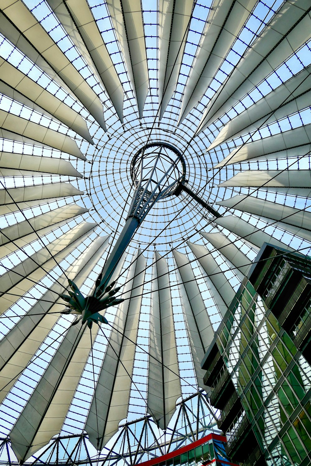 the ceiling of a building with a clock on it