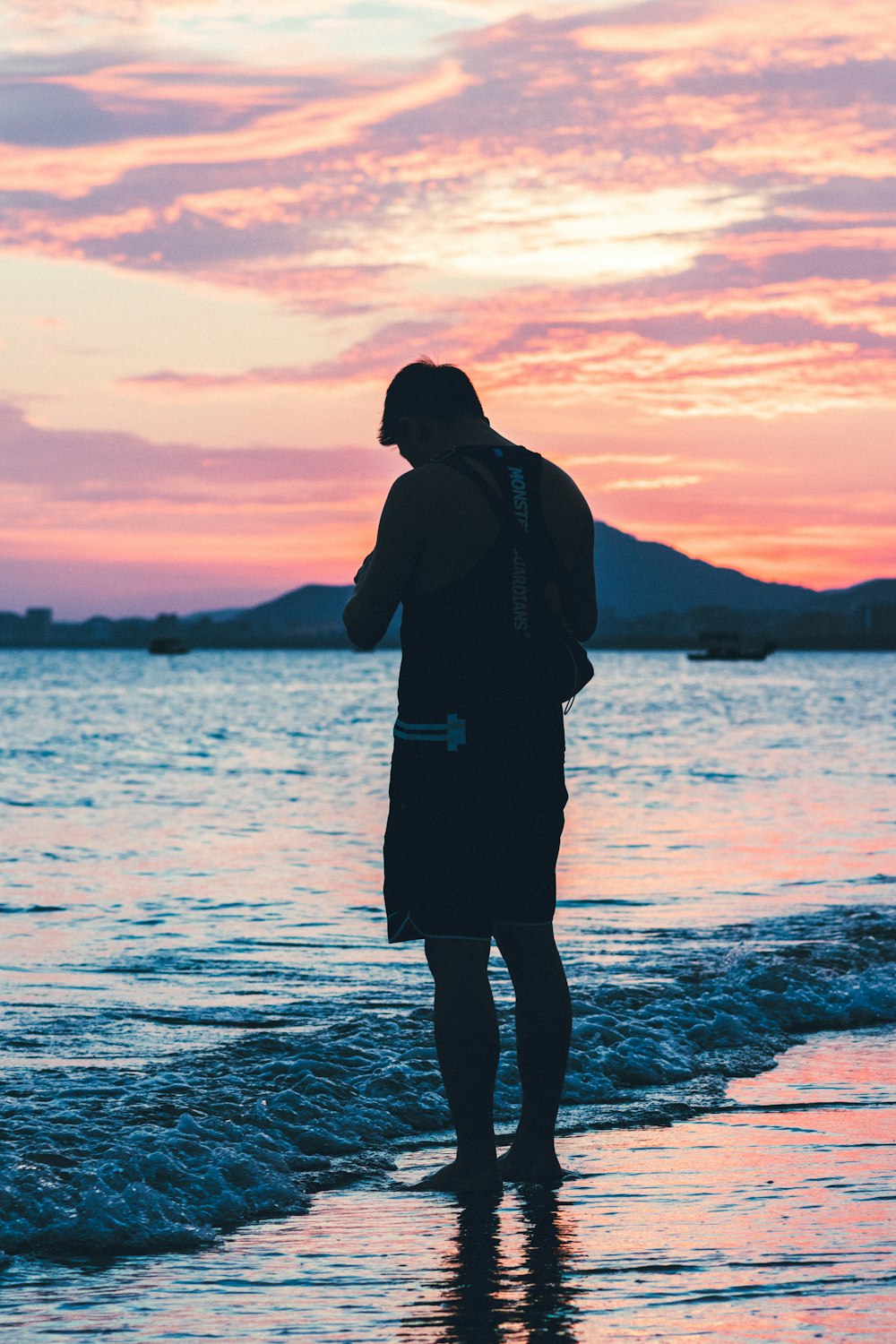 silhouette of man on beach during golden hour