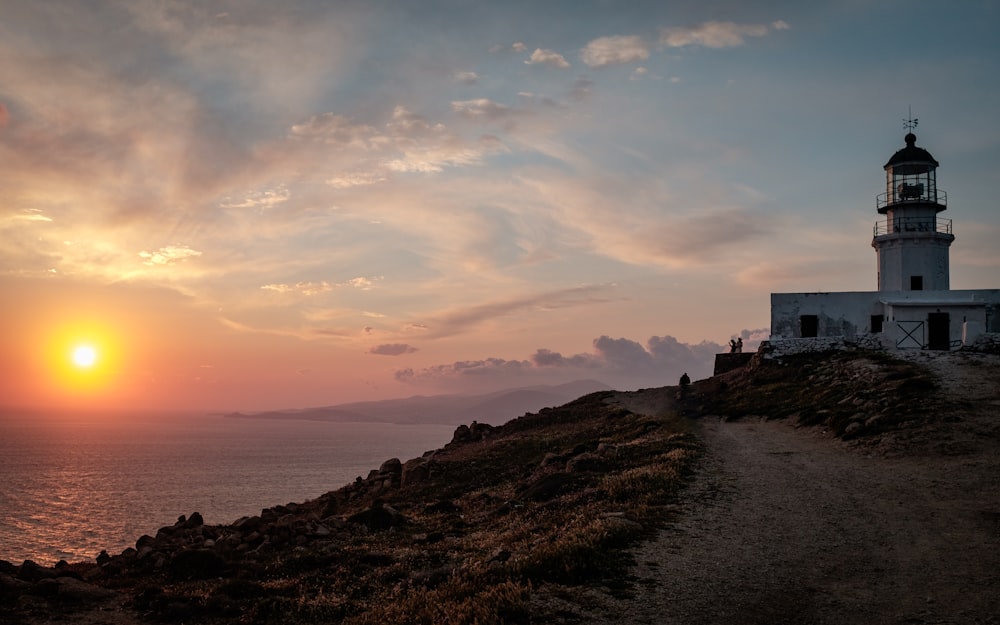 view of white lighthouse during golden hour