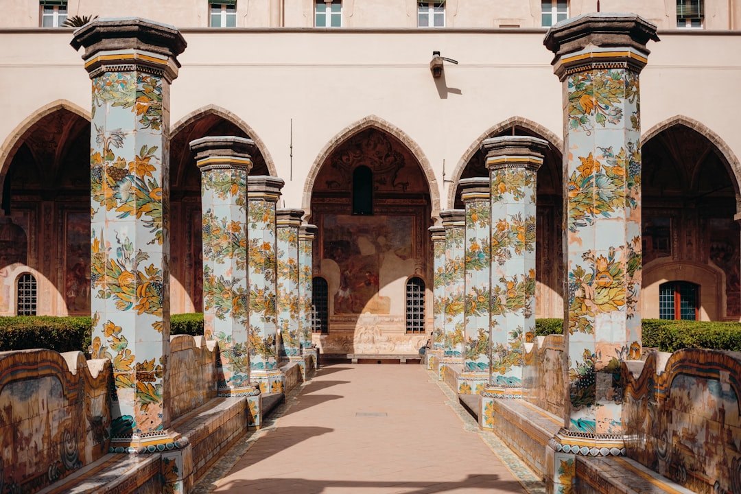 blue, green, and yellow floral painted pillars lining up the hallway