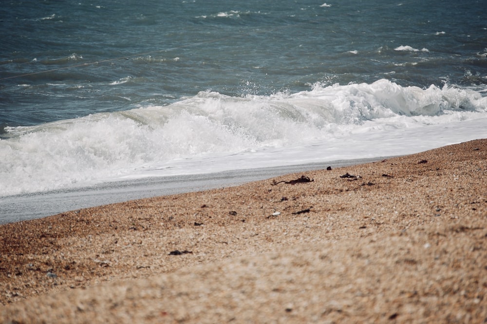 white waves breaking in beach