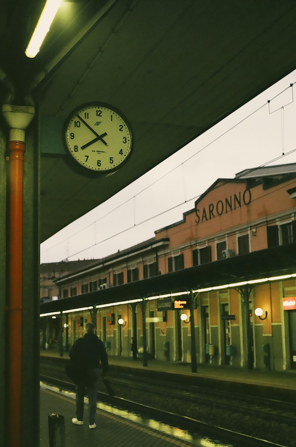 white and black analog wall clock in train station at 7:52