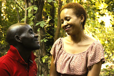 Two local coordinators smiling warmly as they guide a group through an outdoor activity near Fontainebleau.