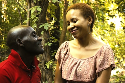 A smiling caregiver engaging happily with a person with developmental disabilities outdoors