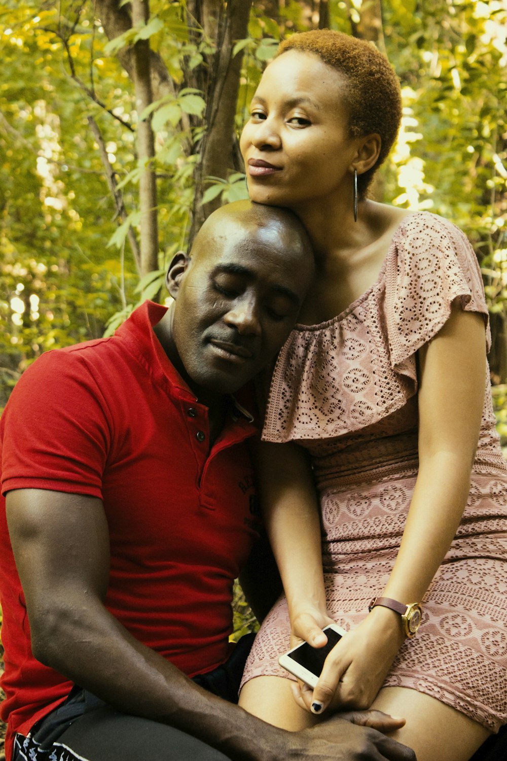 man resting his head on woman's shoulder