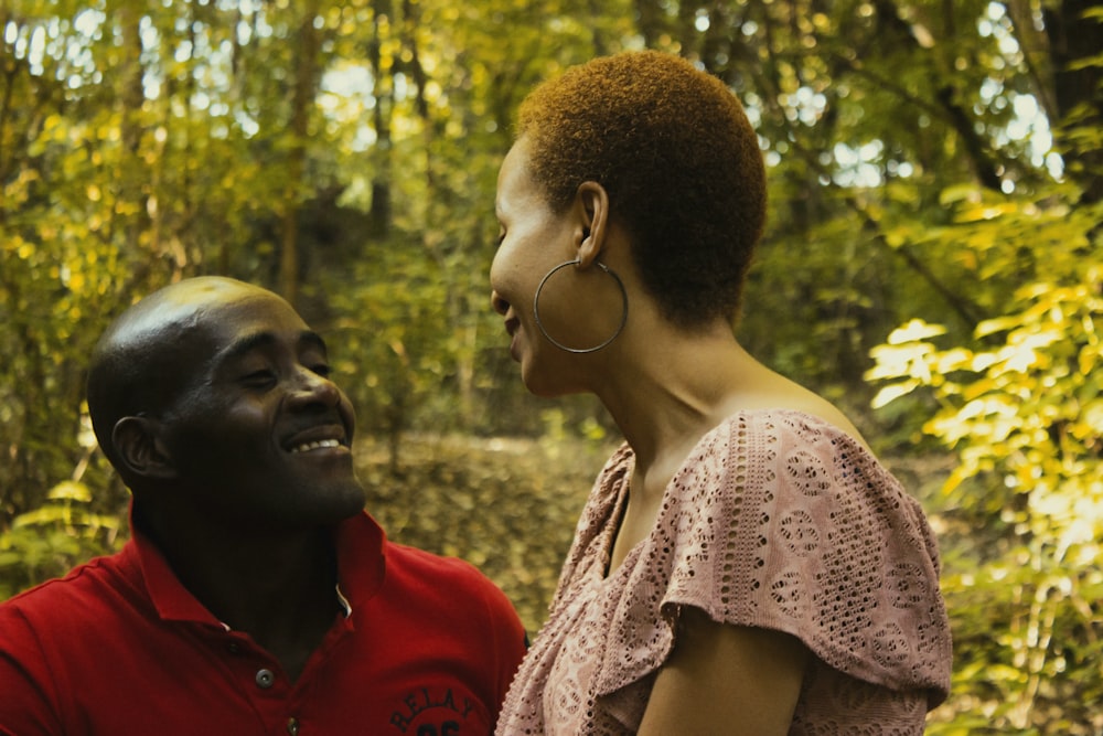 selective focus photography of man and woman near trees