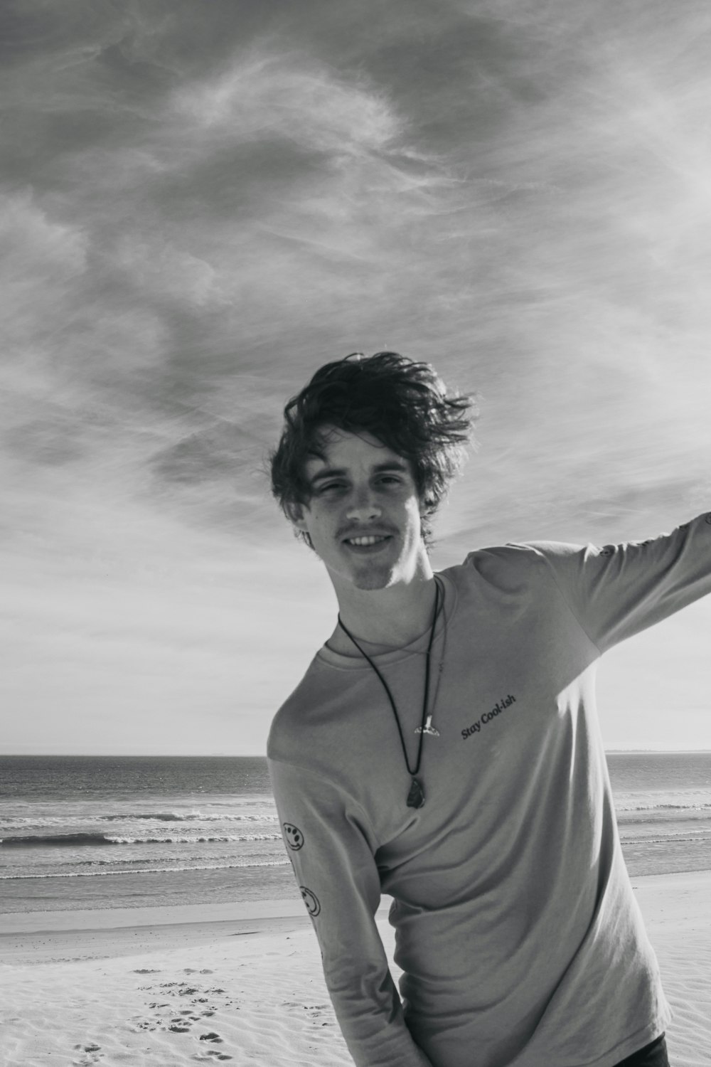 grayscale photography of man on shore