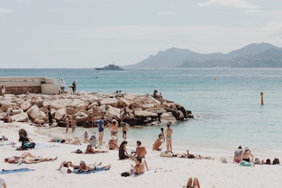 people gathered on seashore during daytime cote d'ivoire google meet background