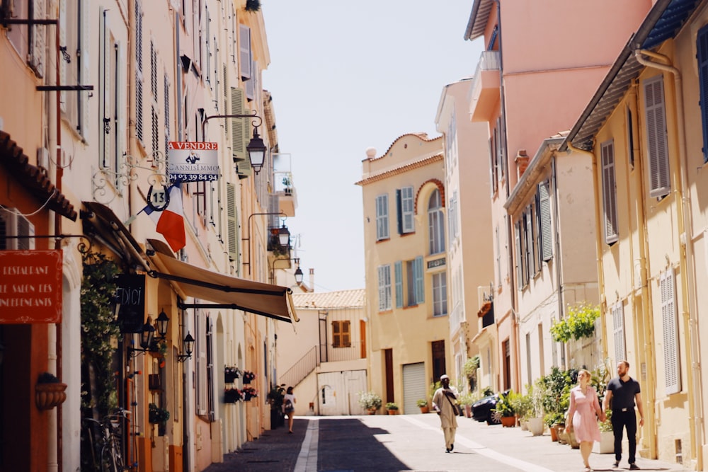 people walking at the streets between buildings during day