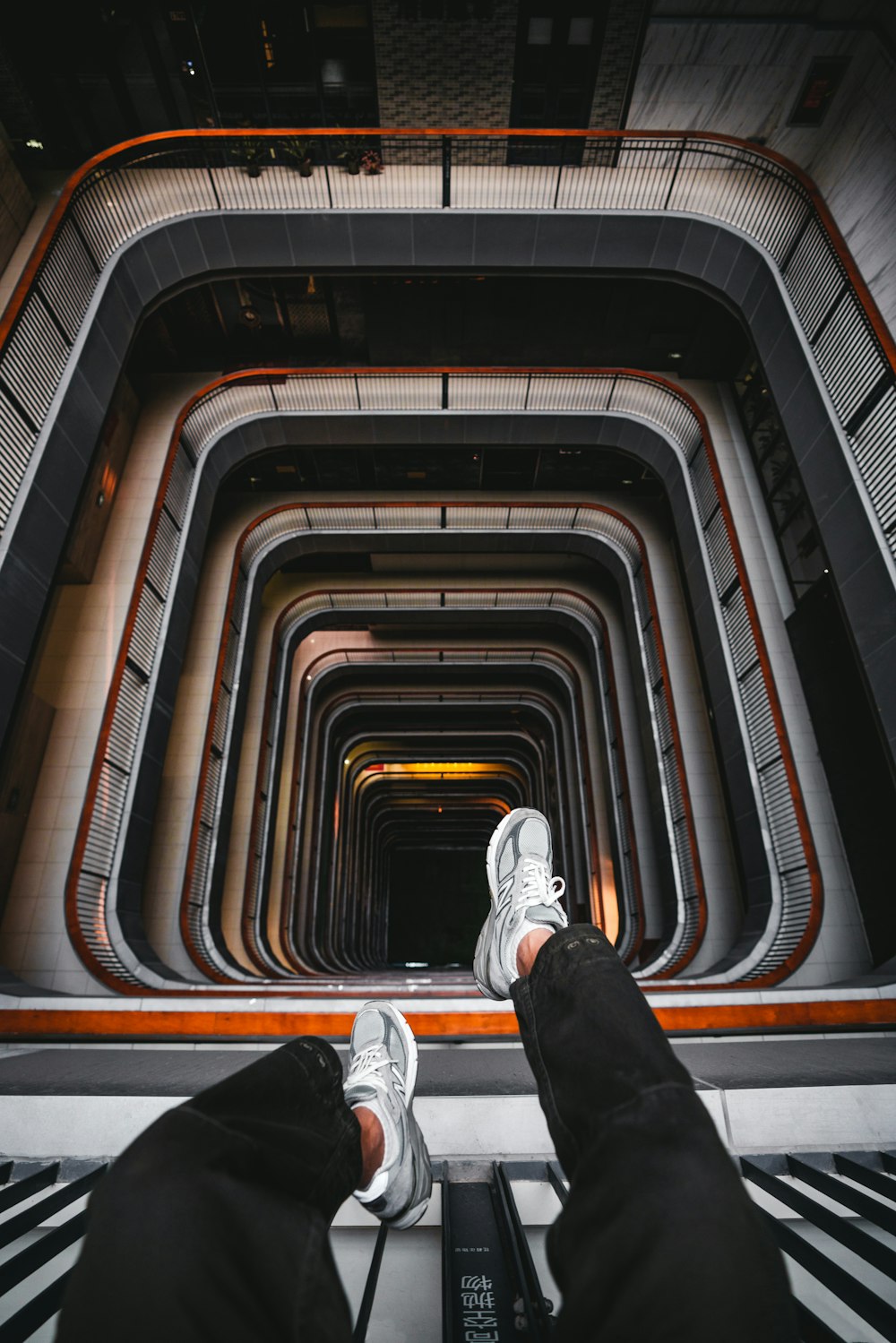 person sitting above stairs