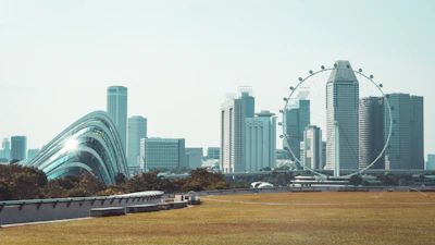 A modern cityscape blending Dublin's historic architecture with Astana's futuristic skyline under a clear sky.