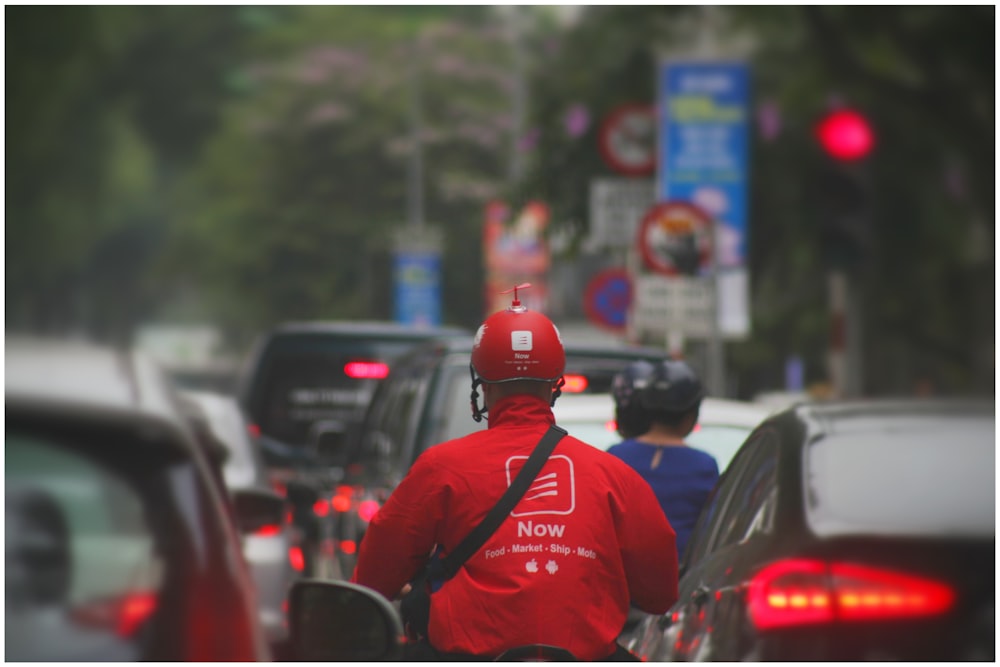 person riding on motorcycle between vehicles