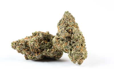 A cluster of ripe buds with visible trichomes glistening under soft light.