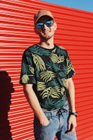 A customer happily wearing a custom-printed outfit outdoors on a sunny day.