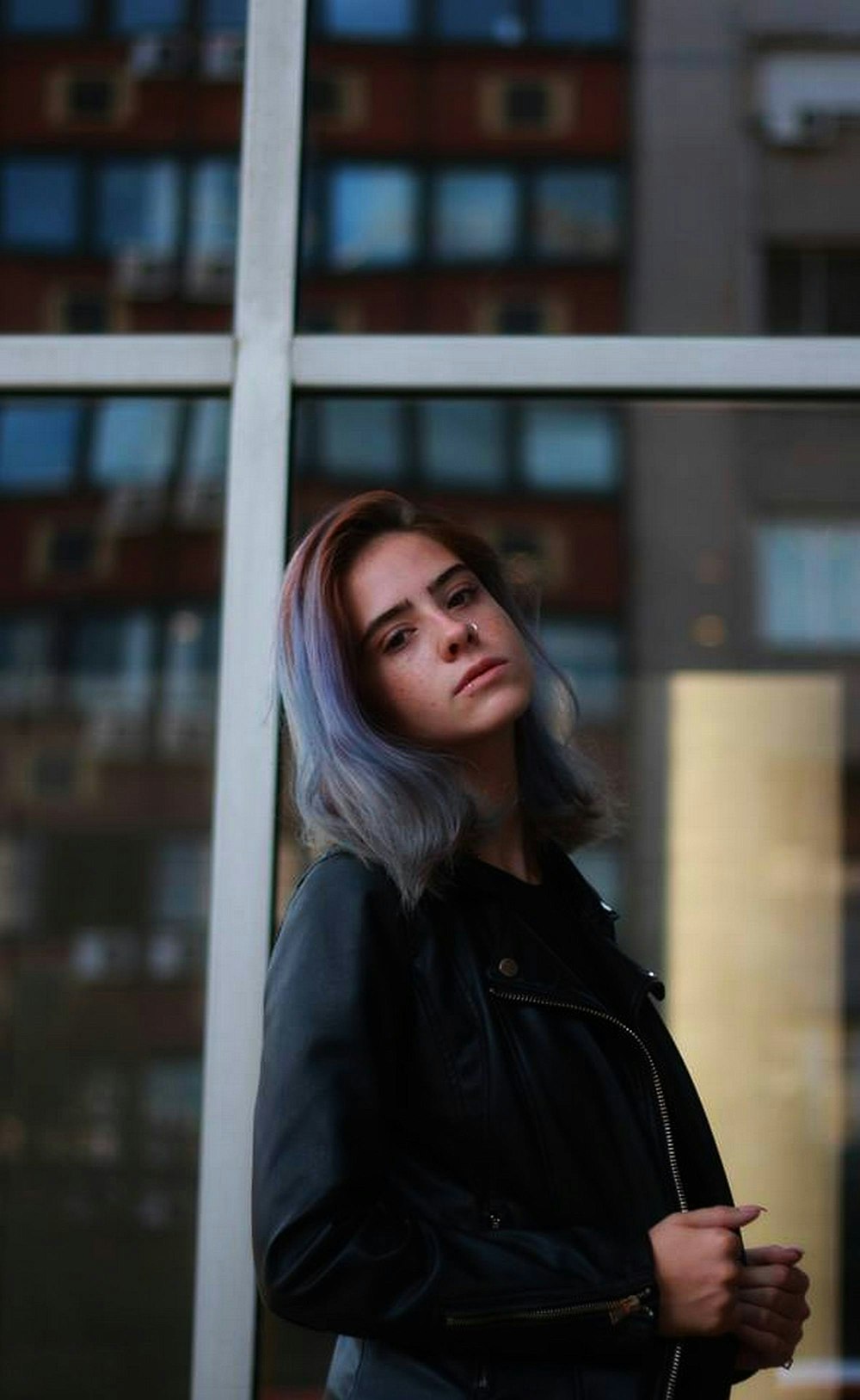 woman standing while wearing black leather jacket