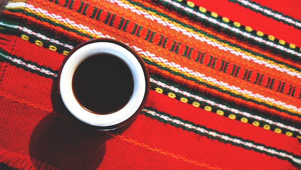 red and white ceramic cup