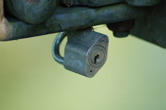 A locksmith repairing a broken padlock.