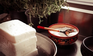 red ceramic bowl on gray spoon