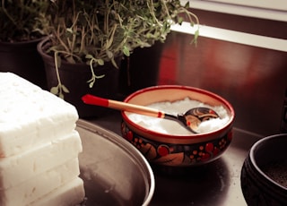 red ceramic bowl on gray spoon