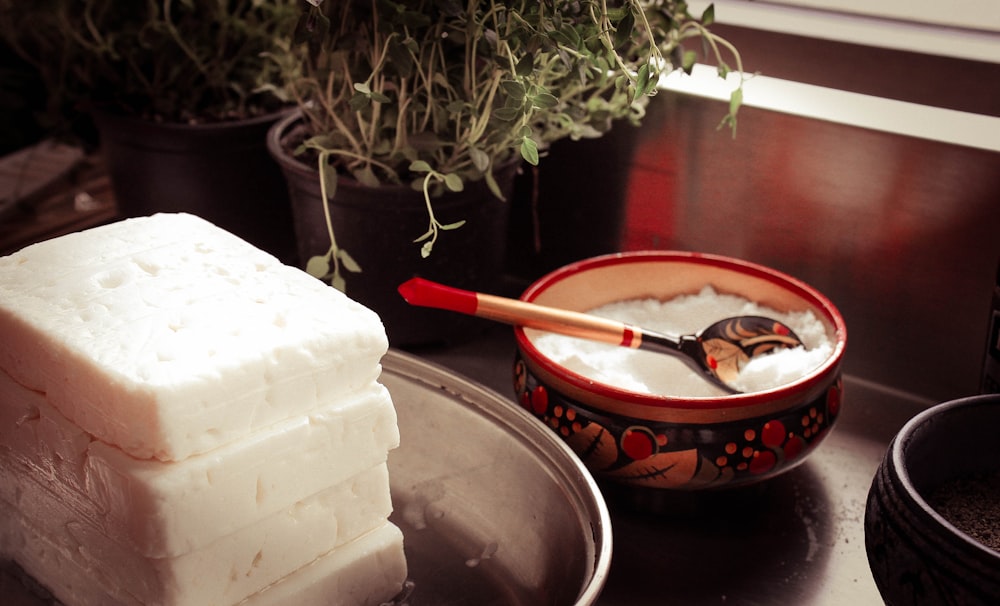 red ceramic bowl on gray spoon