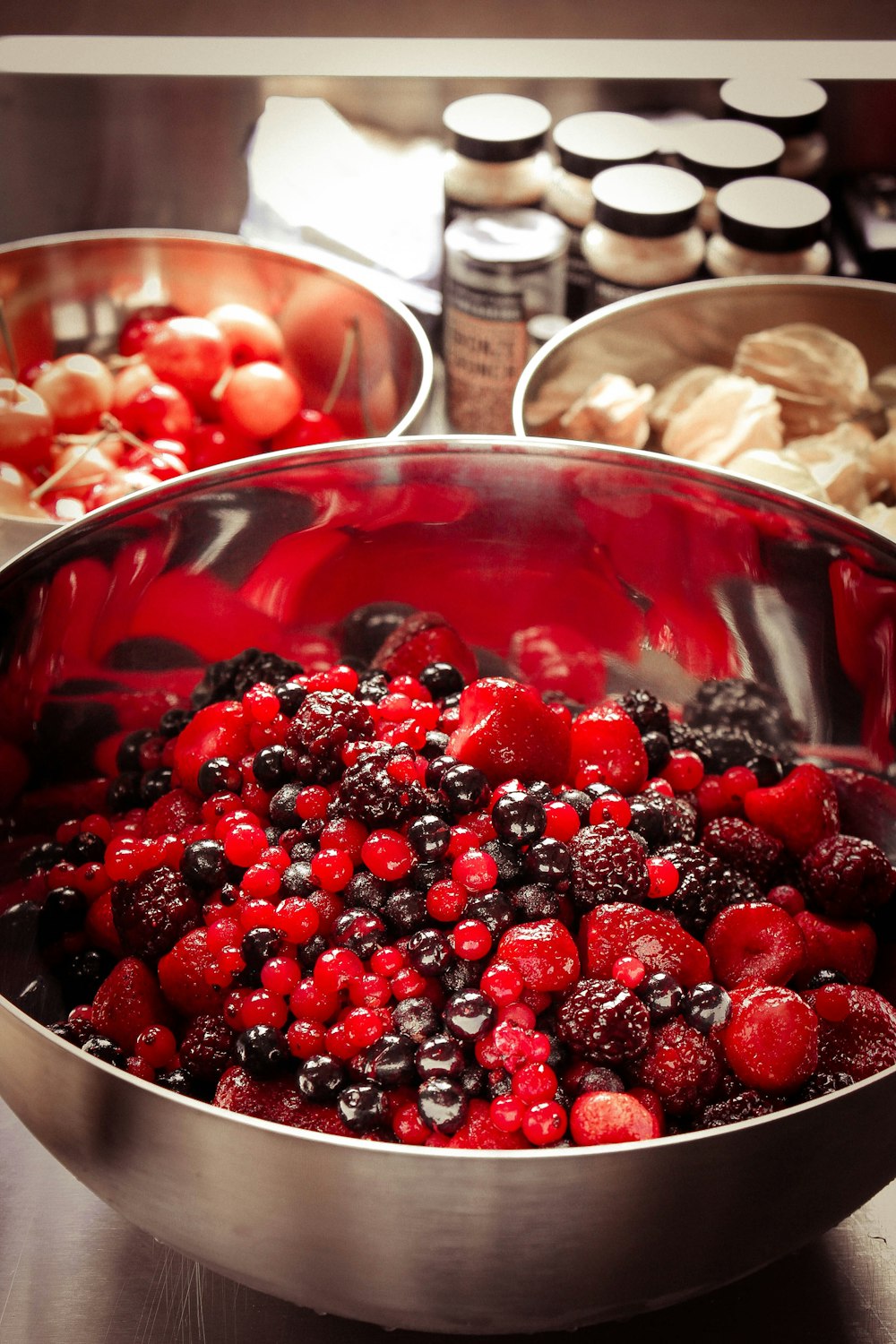 red and black fruit on gray stainless steel bowl