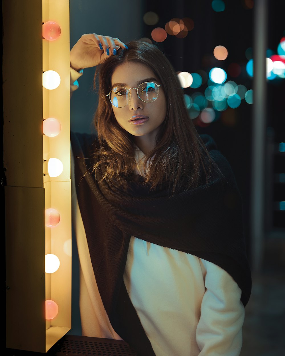 woman leaning near light bulbs