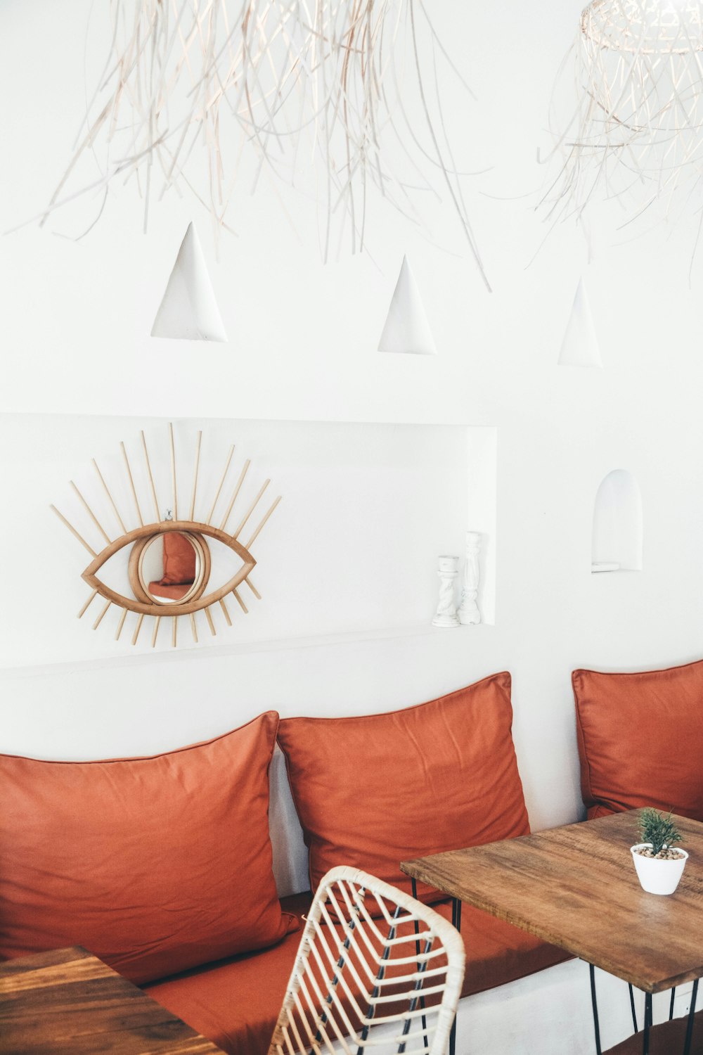 three red throw pillows behind tables