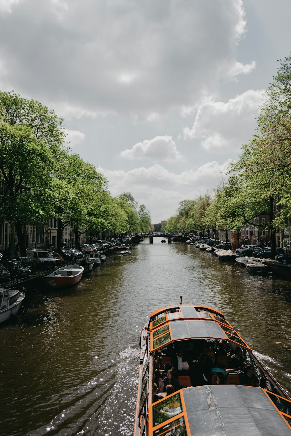 river boat filled with people in canal