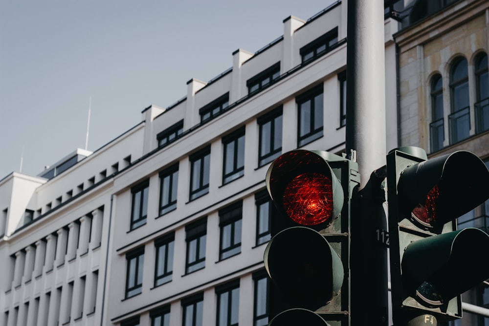 traffic lights near white and brown building