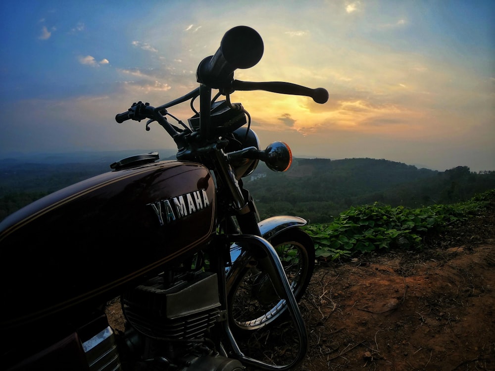 black Yamaha standard motorcycle parked on green and brown surface