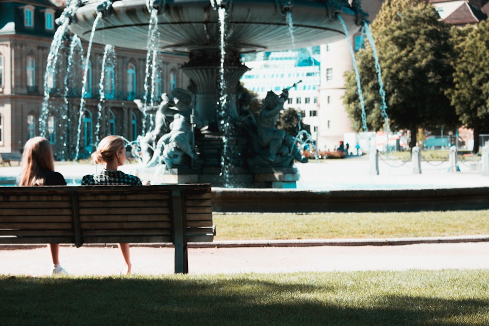 two women sitting on bench