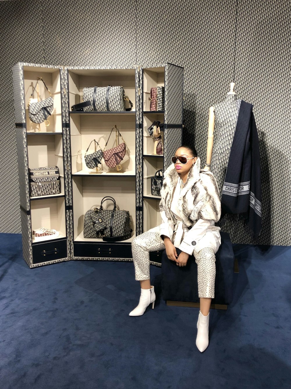 woman sitting on chair near open cabinet