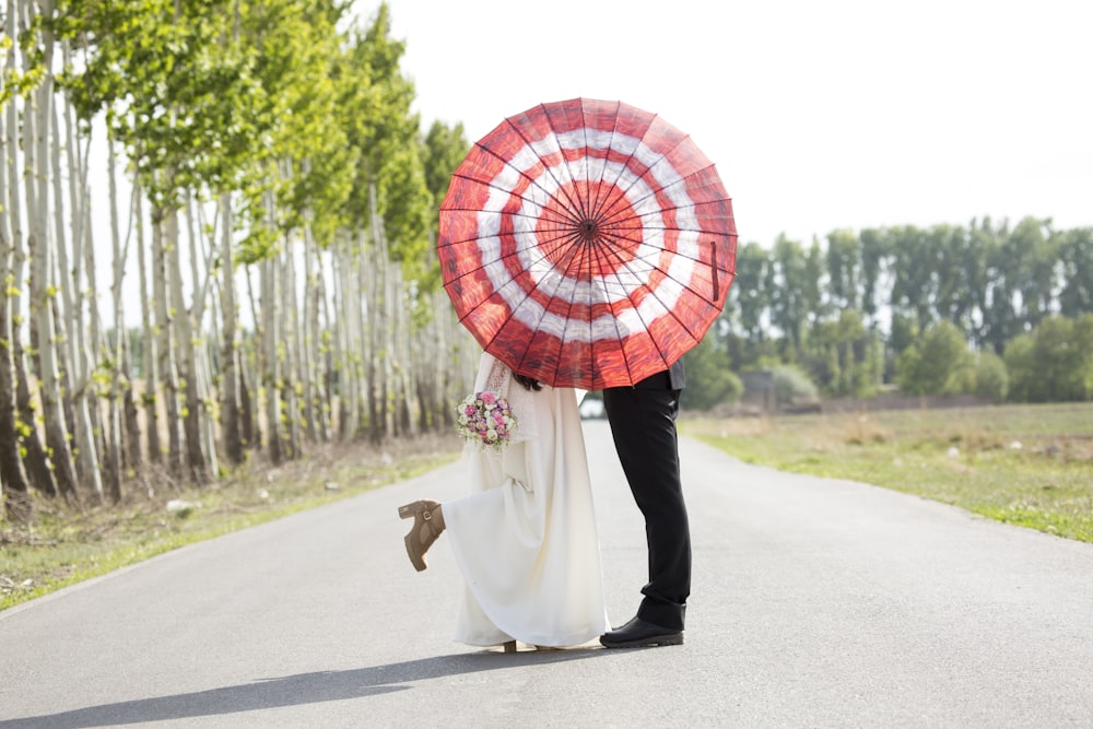 man and woman standing on road