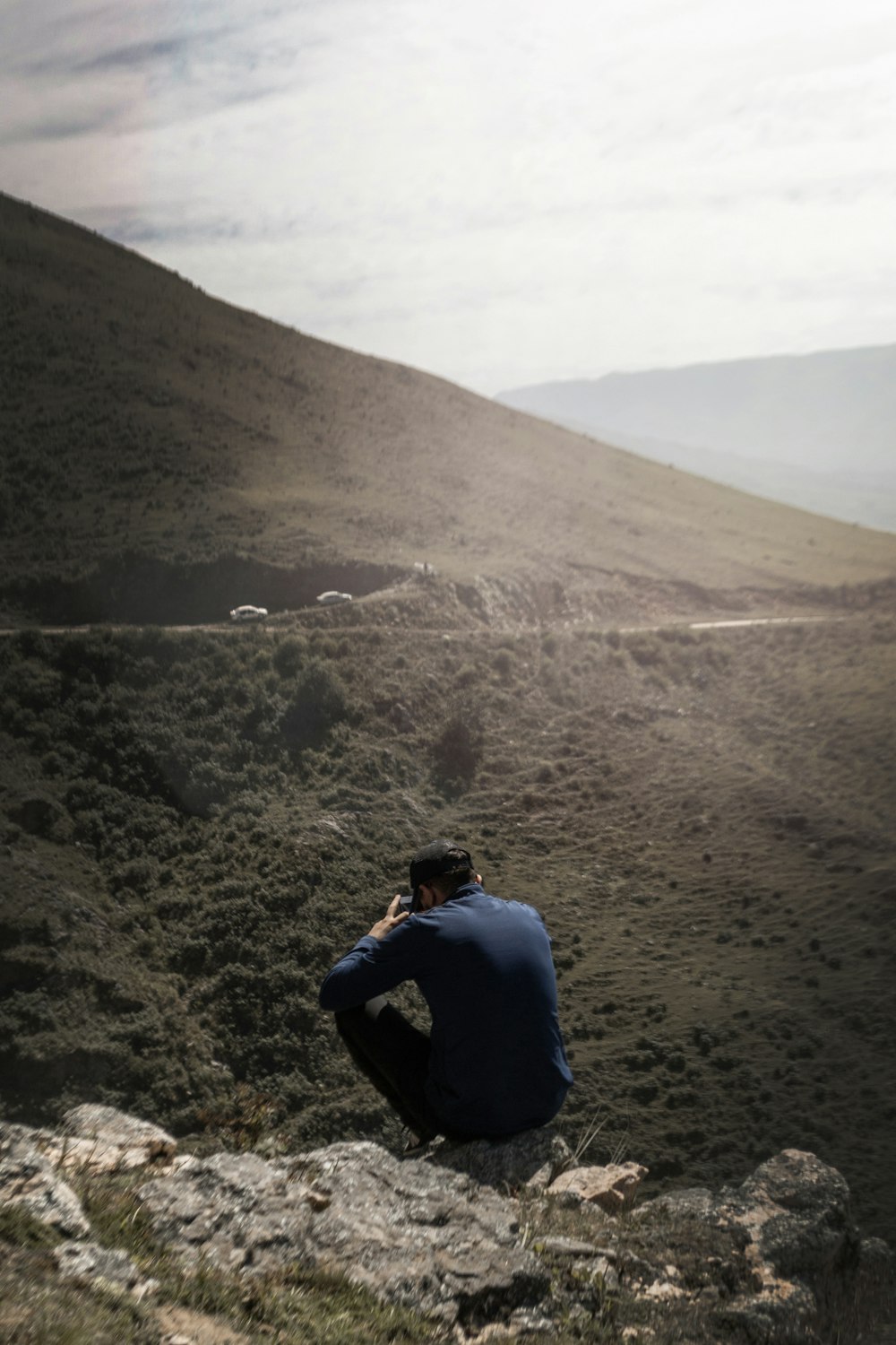man sitting on mountain