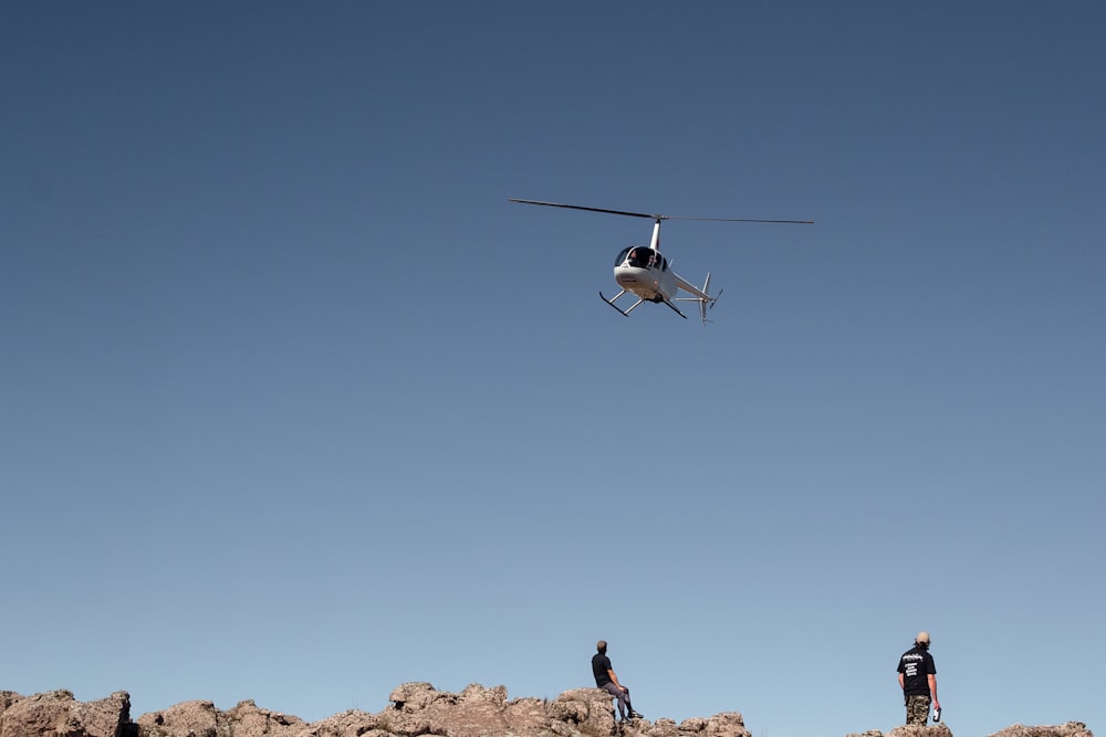 white helicopter under blue sky